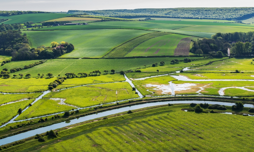 High and over side road view point near Seaford, East Sussex, England. View of Cuckmere river from above, selective focus